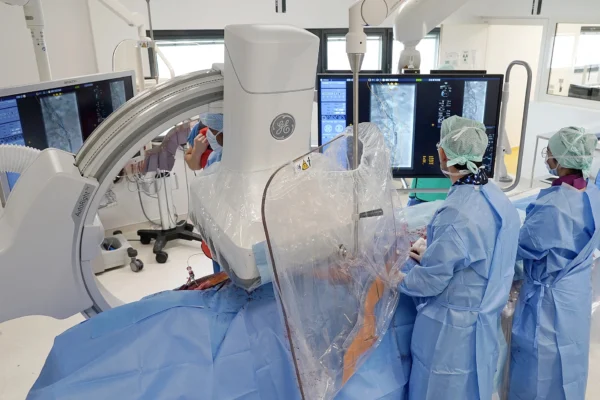 Salle hybride du service de chirurgie vasculaire avec nos chirurgiens opérant un patient